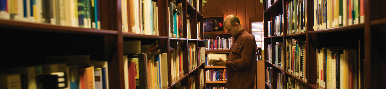 Student reading a book in the Research Library 