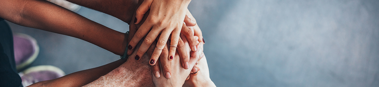 Stack of hands showing unity