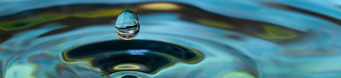 water drop falling and impacting on a body of water close up - Office of the Provost webpage