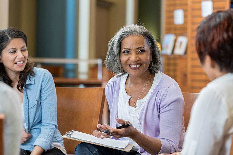 Senior female university professor teaches in casual setting