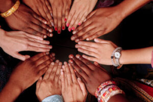 Hands of a group of multinational people which stay together in circle